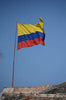 The red, blue, and yellow flag of Colombia on top of a building.