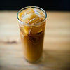 A tall glass of iced coffee.